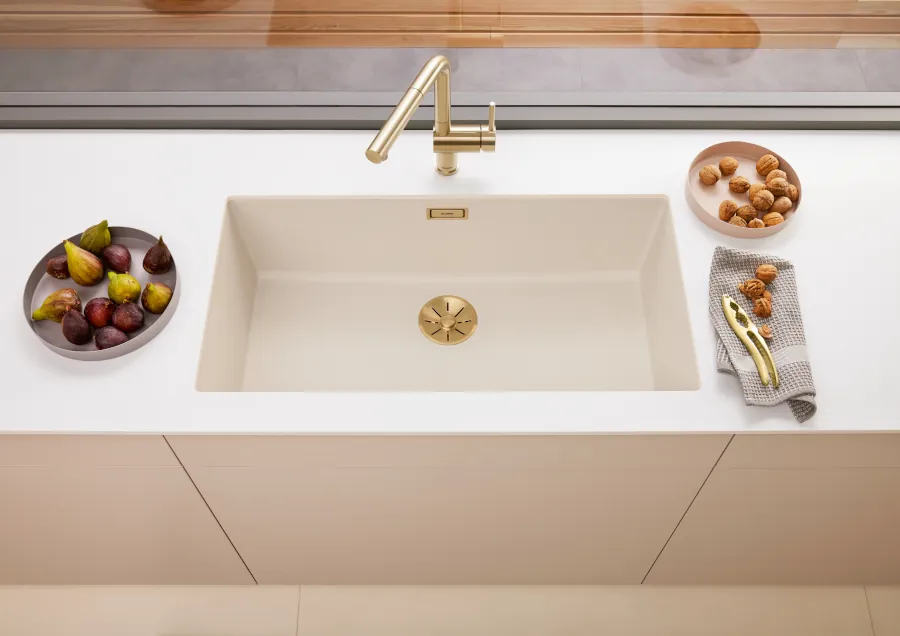 gold tap on white sink